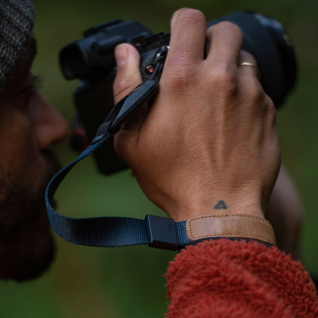 (image), Alving holding his camera with a midnight cuff on his wrist,  CF-MN-3, midnight