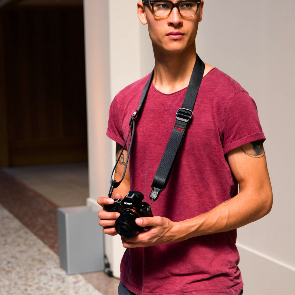 (image), Alvin wearing the black Slide Lite with his camera around his neck, SLL-BK-3, black