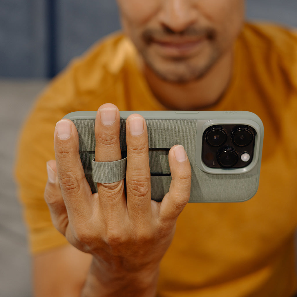 (image), Maria holding his iPhone 12 Pro Max vertically using the finger loop on its Everyday case, M-LC-BJ-CH-1