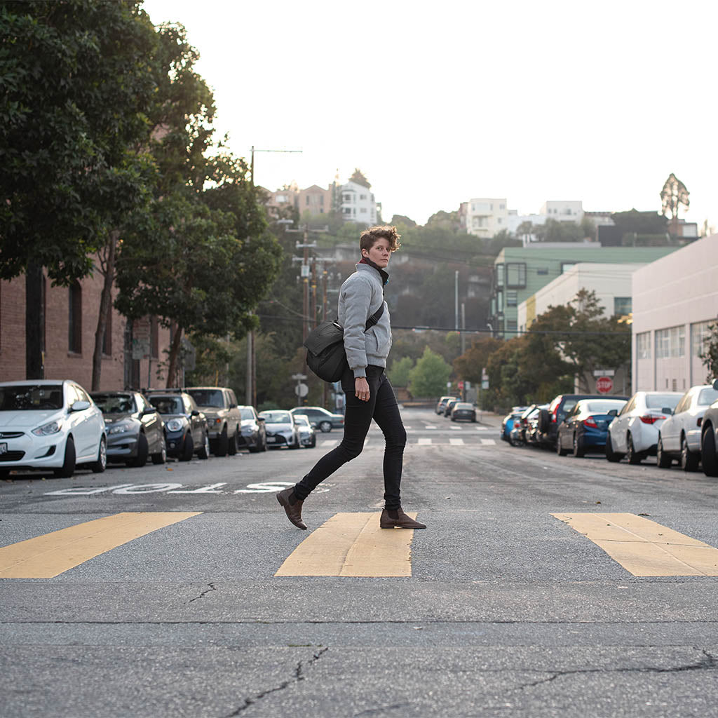 (image), Adrienne walking down the street with her Black Everyday Messenger, BEDM-13-BK-2, black