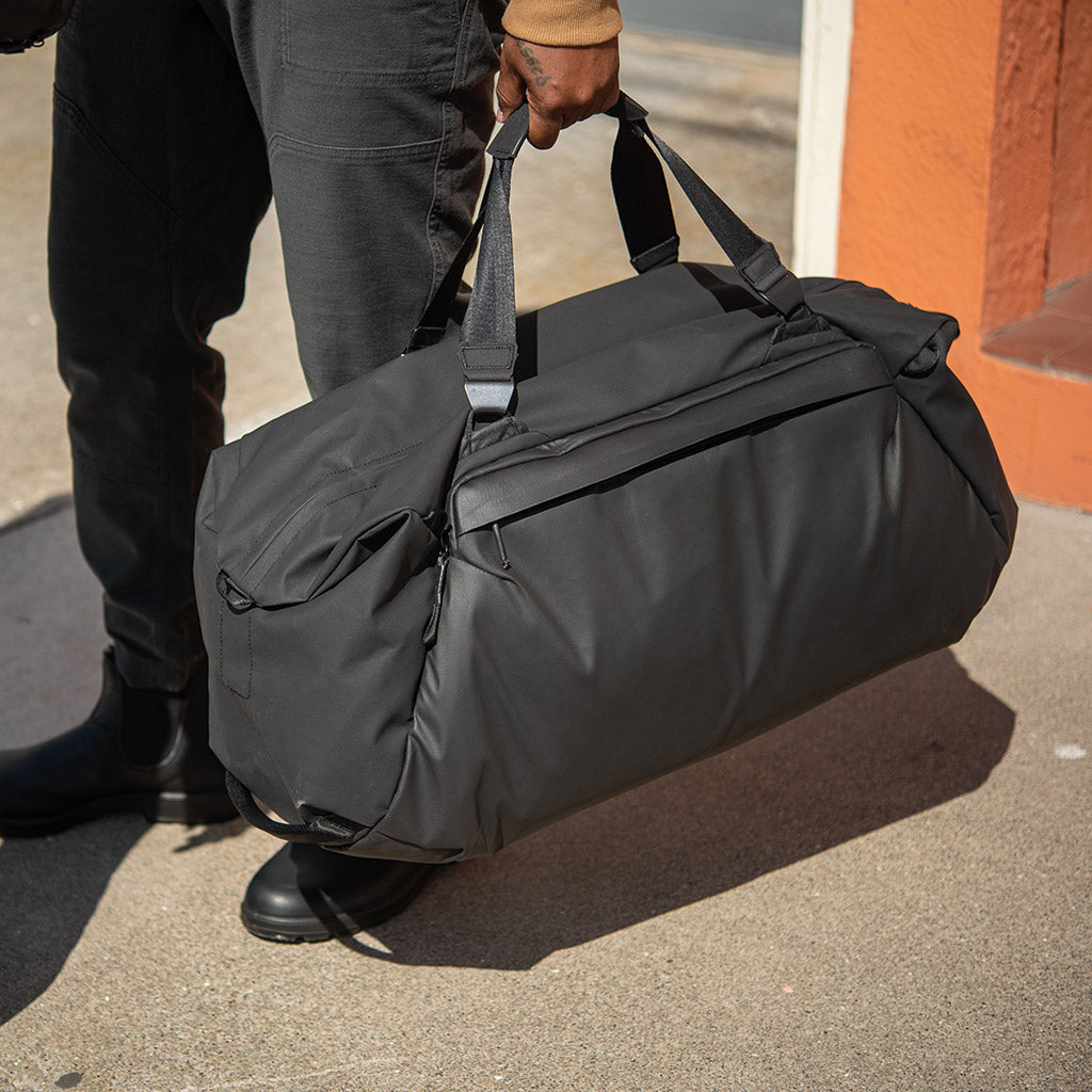 (image), Alvin carrying his black 65L duffel, BTRD-65-BK-1