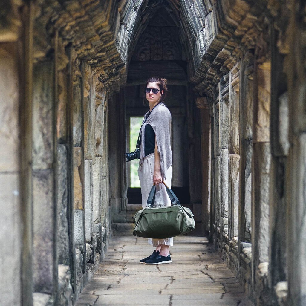 (image), Anne traveling using her 35L travel duffel, BTRD-35-SG-1, sage